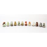 A collection of twelve porcelain Friends of the Forest thimbles in a vintage leather jewellery