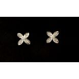 A pair of 9ct white gold diamond set flower shaped earrings, L. 0.6cm.