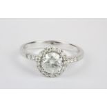 An 18ct white gold (stamped 750) halo ring set with an 0.88ct brilliant cut centre diamond