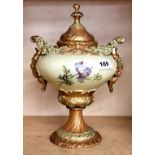 A 19th Century hand painted Continental porcelain urn and lid with green man handles, H. 30cm.