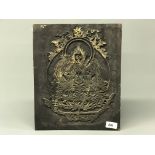 A Tibetan carved wooden panel with decoration of a seated Tara used for hand printing prayer