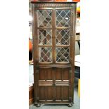 A carved oak and leaded glass corner cabinet, 170 x 66 x 46cm.
