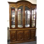 A carved walnut display cabinet, W. 145cm H. 205cm.