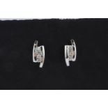 A pair of 18ct white gold stud earrings set with three brilliant cut diamonds, L. 1.2cm.