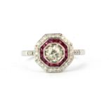 An Art Deco style 18ct white gold ring set with an 0.70ct old cut centre diamond, rubies and