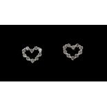 A pair of 18ct white gold diamond set heart shaped stud earrings, L. 0.5cm.