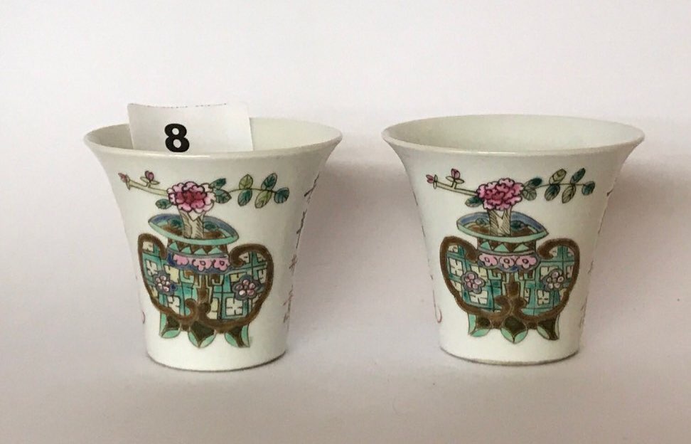 A pair of Chinese hand enamelled porcelain cups. H. 6cms. Condition of both appears to be good