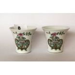 A pair of Chinese hand enamelled porcelain cups. H. 6cms. Condition of both appears to be good