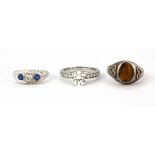A 925 silver tiger's eye set ring together with two further 925 silver stone set rings.