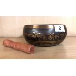 A Tibetan bronze singing bowl with pressed steel central decoration of five seated Buddha, Dia. 16cm