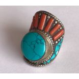 A Tibetan man's Kampa tribe stone set white metal ring. Top L. 3.5cms. Internal dia. 2cms. Condition