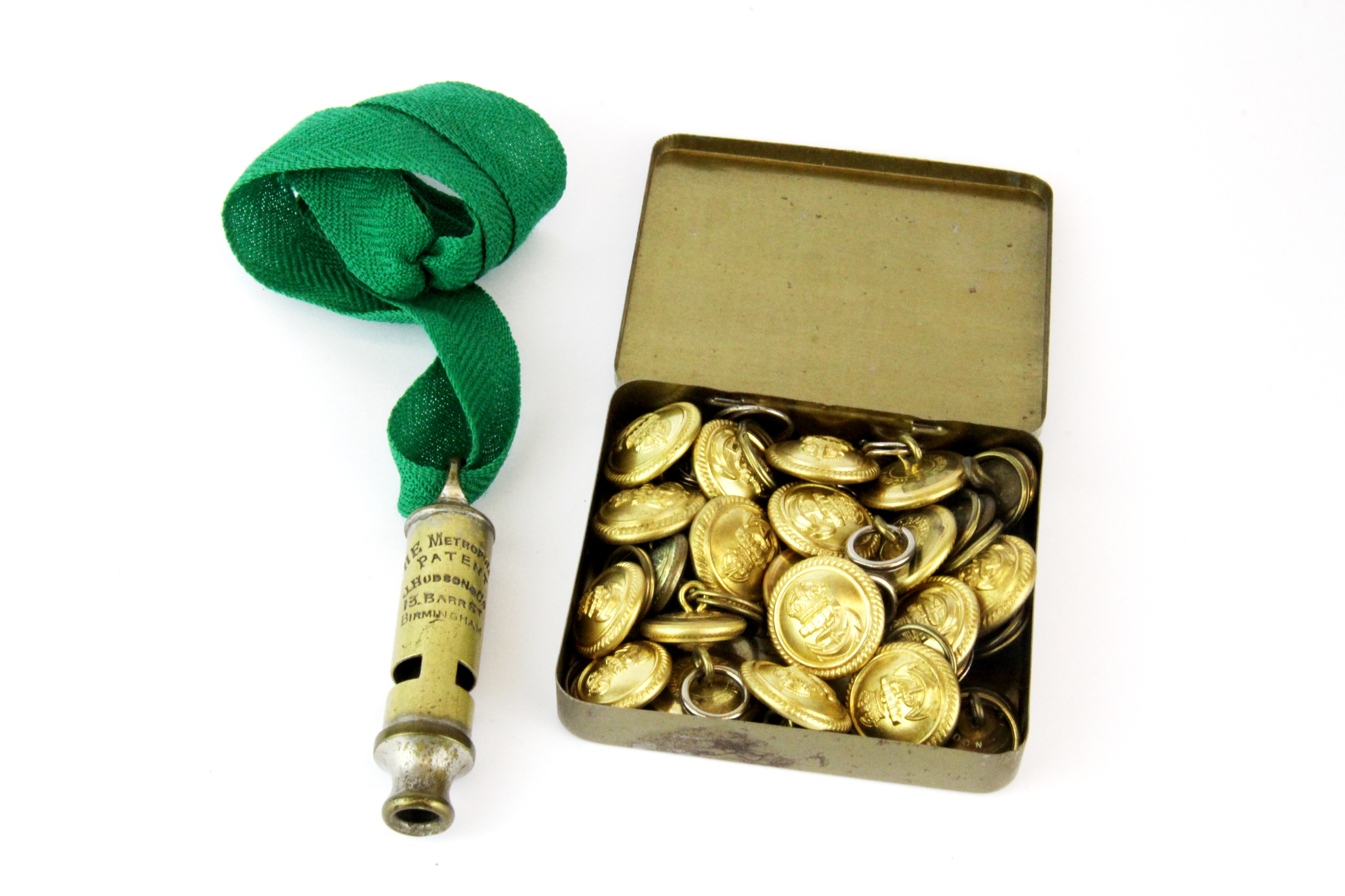 An early Metropolitan police whistle together with a quantity of buttons.