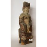 An early 20thC Chinese carved wooden ancestor figure of a woman with bound feet wearing robes and
