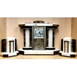 An Art Deco onyx and marble clock garniture, H. 37cm. Condition : appears complete but movement