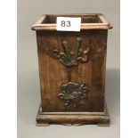 A Chinese hardwood brush pot in square form decorated with sacred symbols. H. 19cms. Condition