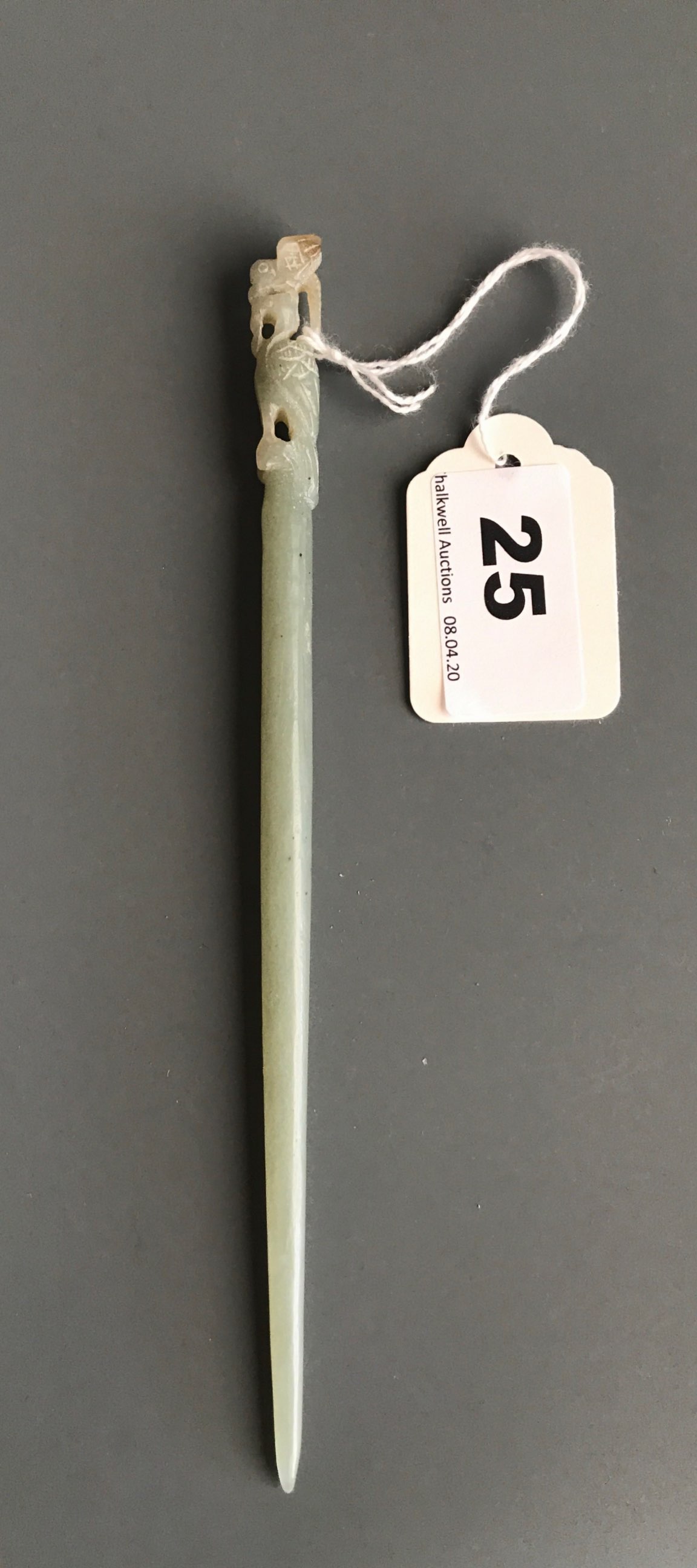 A 19th/early 20thC Chinese carved nephrite jade hair pin with top decoration of a small bird sitting