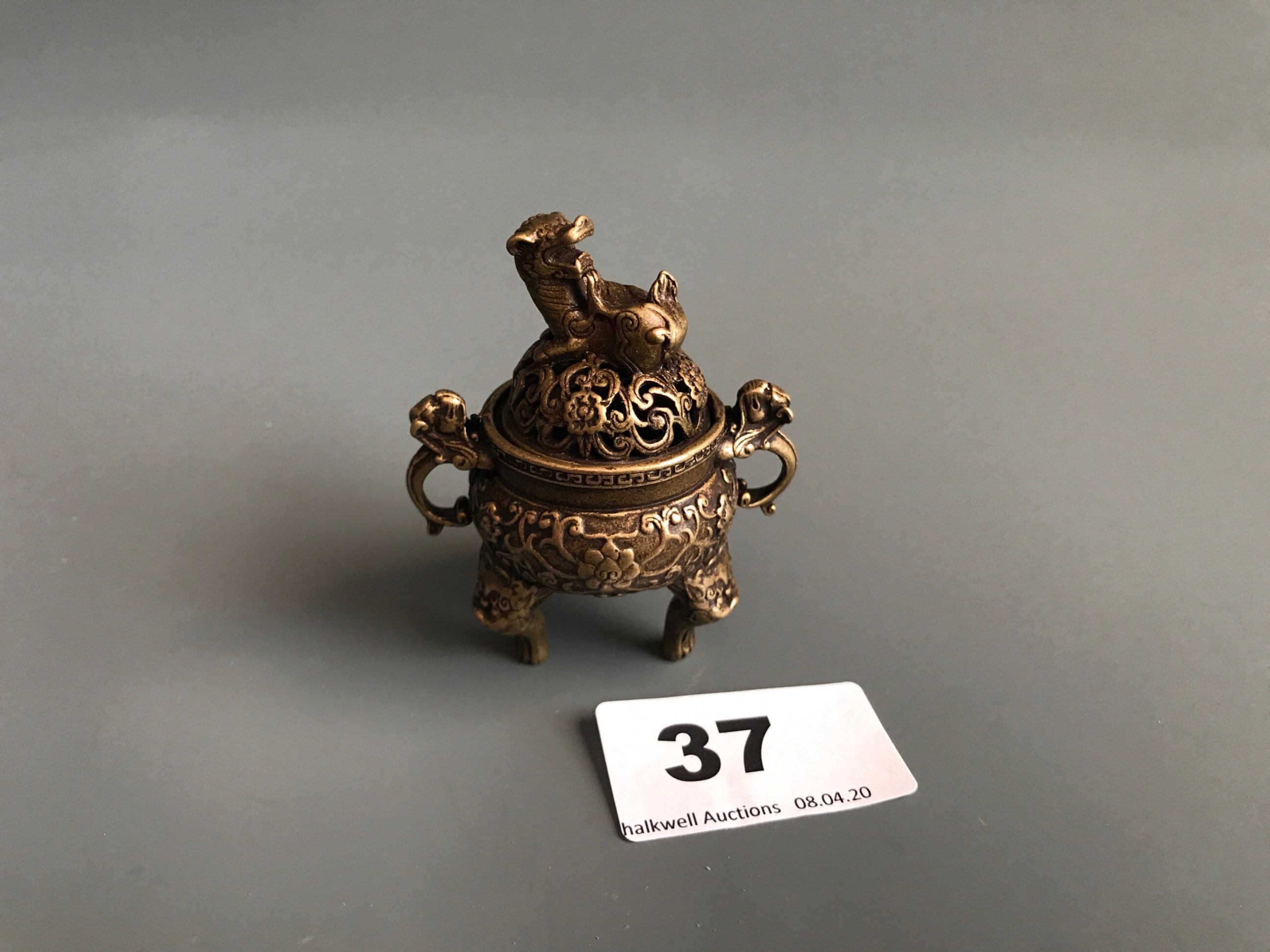 An early 20th Century Chinese polished bronze/brass censer with elephant head handles, H. 30cm.