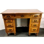 A leather topped oak desk on casters, 106 x 55 x 75cm.