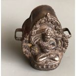 A Tibetan hammered copper and bronze fronted ga'u or portable shrine. H. 8cms. Condition good but
