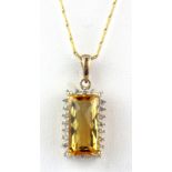 A 9ct yellow gold citrine and diamond set pendant and chain, L. 2.5cm.