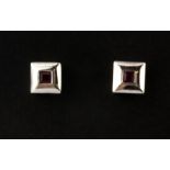 A pair of 9ct white gold ruby set stud earrings, L. 0.5cm.