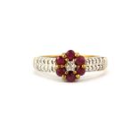 A 9ct yellow gold ruby and diamond set daisy cluster ring