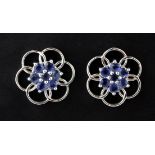 A pair of 9ct white gold flower shaped stud earrings set with sapphires, Dia. 2cm.