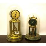 Two vintage torsion pendulum clocks with glass domes, one with enamelled clock face, tallest overall