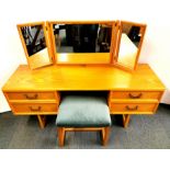 A 1970's pine dressing table, with upholstered stool, 150 x 45 x 63cm.