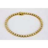 A 14ct yellow gold (stamped 14k) diamond set tenis bracelet, approx. 3.5ct overall, L. 18cm.