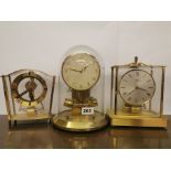 Three vintage magnetic pendulum clocks with battery electric movements, with glass dome, tallest