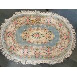 An oval Chinese wash wool rug, 200 x 145cm, together with a small washed wool rug, 150 x 60cm.