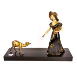 An original Art Deco painted metal and slate figure of a lady with a faun, L. 60cm H. 44cm.
