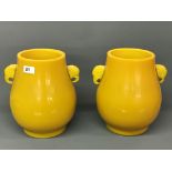 A superb pair of Imperial Yellow Peking glass vases with elephant head handles. H. 27cms.
