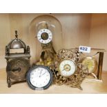 A group of four mixed alarm and mantle clocks with an exhibition style skeleton clock and dome by