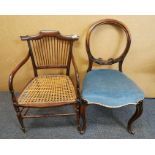 An Arts and Crafts Rush seated armchair and a Victorian balloon back chair.