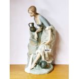 A large Nao porcelain figure of a girl beside a spring, H. 33cm.