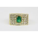 A heavy gentleman's 18ct yellow gold (stamped 750) ring set with an emerald cut emerald and