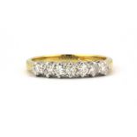 An 18ct yellow and white gold half eternity ring set with brilliant cut diamonds, (L).