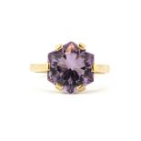 A 9ct yellow gold ring set with an unusually cut hexagonal amethyst, (R).