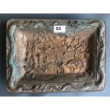 A heavy 1920's bronze dish mounted on four feet and relief decorated with a temple garden landscape.