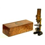 An early brass microscope in a burr walnut inlaid case, H. 18cm.