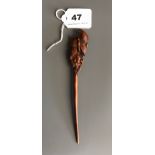 A carved fruitwood hair ornament decorated with a butterfly and flowers. L. 18cms. Condition good