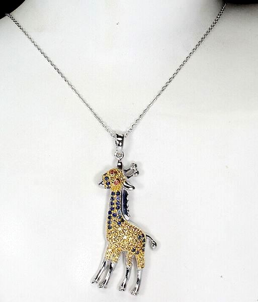 A 925 silver giraffe shaped pendant and chain set with sapphires and fancy yellow sapphires, L.