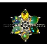 A 925 silver cluster ring set with cabochon cut opals and black spinels, (Q).