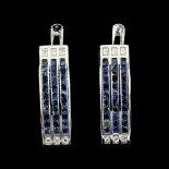 A pair of 925 silver earrings set with three rows of round cut sapphires, L. 2.1cm.