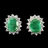 A pair of 925 silver cluster stud earrings set with oval cut emeralds and cubic zirconia, L. 1.2cm.