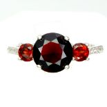 A 925 silver garnet set ring, (O.5).