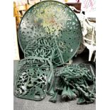 A painted circular metal garden table, Dia. 105cm and four metal chairs currently dismantled.