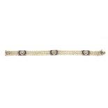 An Art Deco white metal (tested high carat gold or platinum) pearl bracelet set with sapphires and